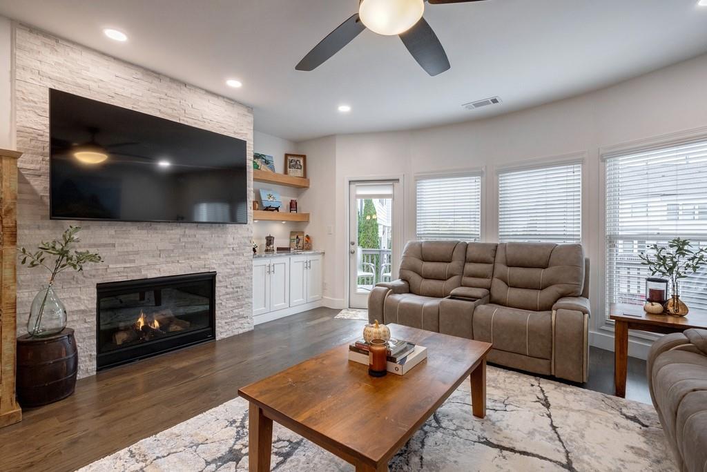 3908 Charleston Market Street Northwest Suwanee, GA 30024 - Photo 8 of 58 a living room with furniture and a flat screen tv