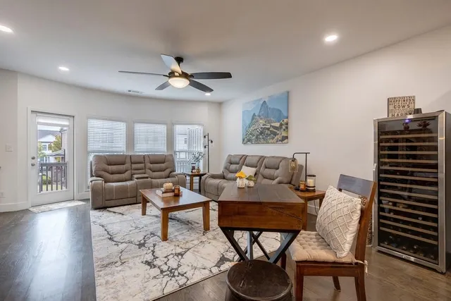 a living room with furniture a flat screen tv and a fireplace