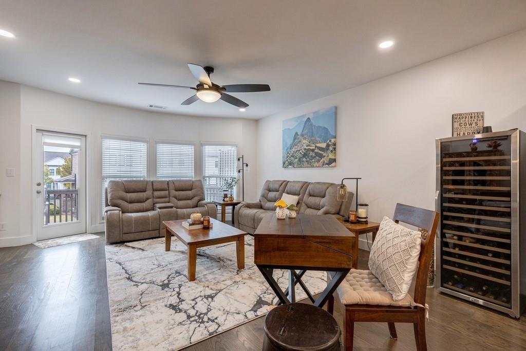 3908 Charleston Market Street Northwest Suwanee, GA 30024 - Photo 9 of 58 a living room with furniture a rug and a chandelier