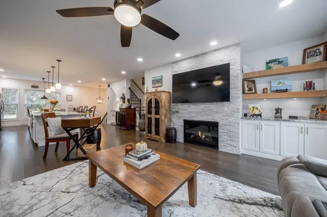 a living room with furniture a fireplace and a flat screen tv