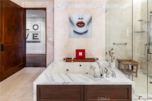 a large bathroom with a large mirror vanity sink and a bathtub