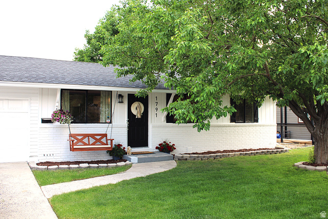 1791 West 170 South, Unit 8 Provo, UT 84601 - Photo 2 of 25 White brick and vertical siding exterior with a dark asphalt shingle roof
