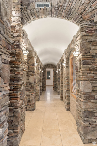 2464 East Granite Way St. George, UT 84790 - Photo 26 of 106 Hallway featuring a barrel ceiling, arched walkways, and light tile patterned flooring
