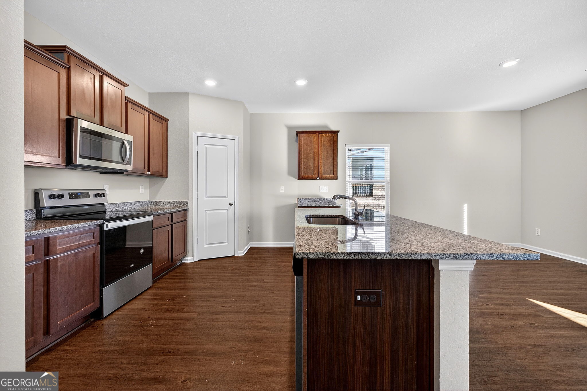805 Golden Bell Way Villa Rica, GA 30180 - Photo 12 of 51 a kitchen with stainless steel appliances granite countertop a sink stove and refrigerator