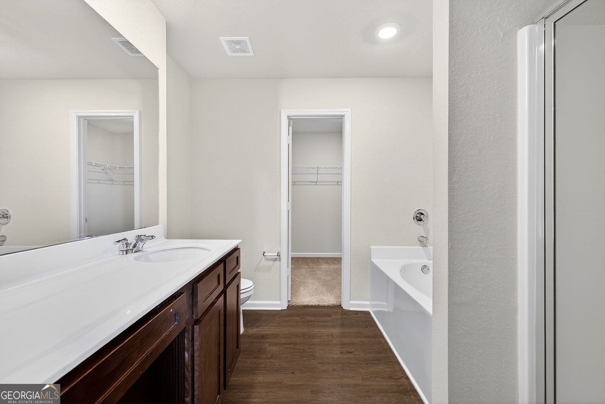 805 Golden Bell Way Villa Rica, GA 30180 - Photo 19 of 51 a bathroom with a sink a mirror and a bathtub