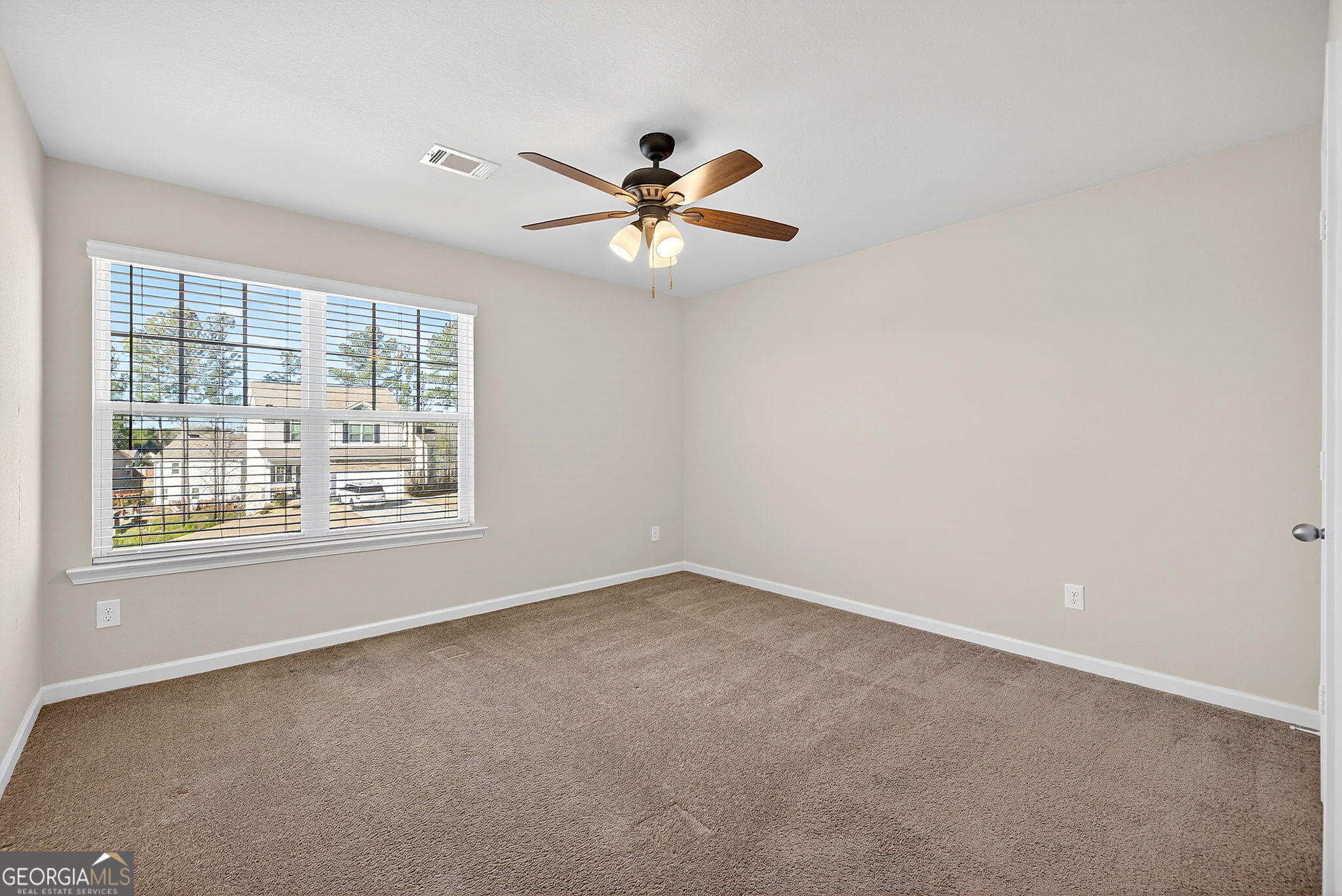 805 Golden Bell Way Villa Rica, GA 30180 - Photo 25 of 51 an empty room with a window and a fan