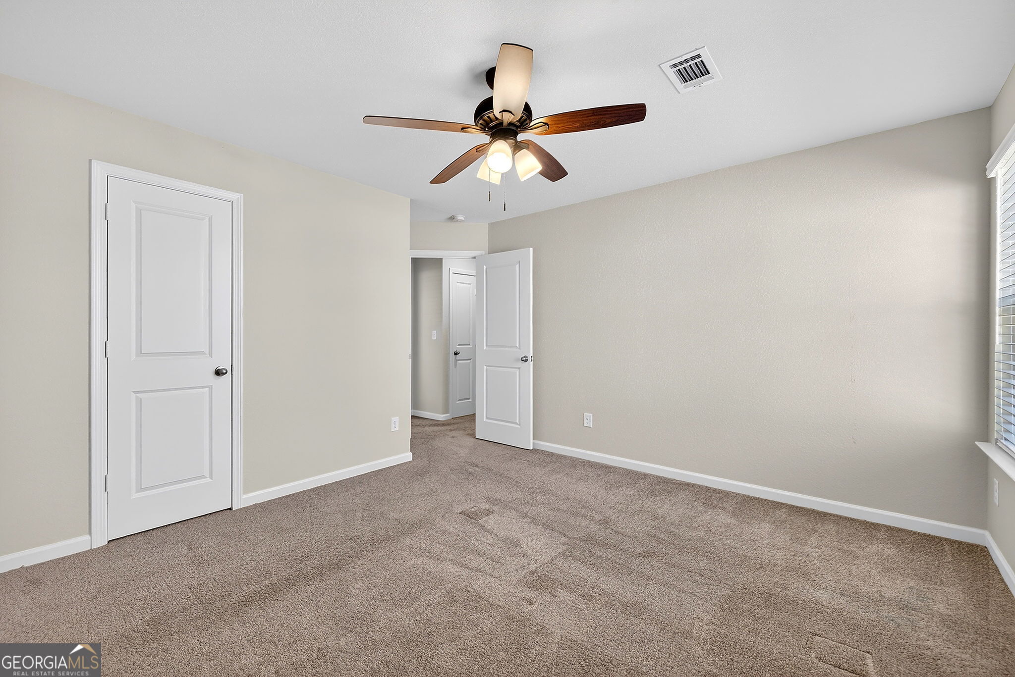805 Golden Bell Way Villa Rica, GA 30180 - Photo 26 of 51 a view of an empty room and a ceiling fan