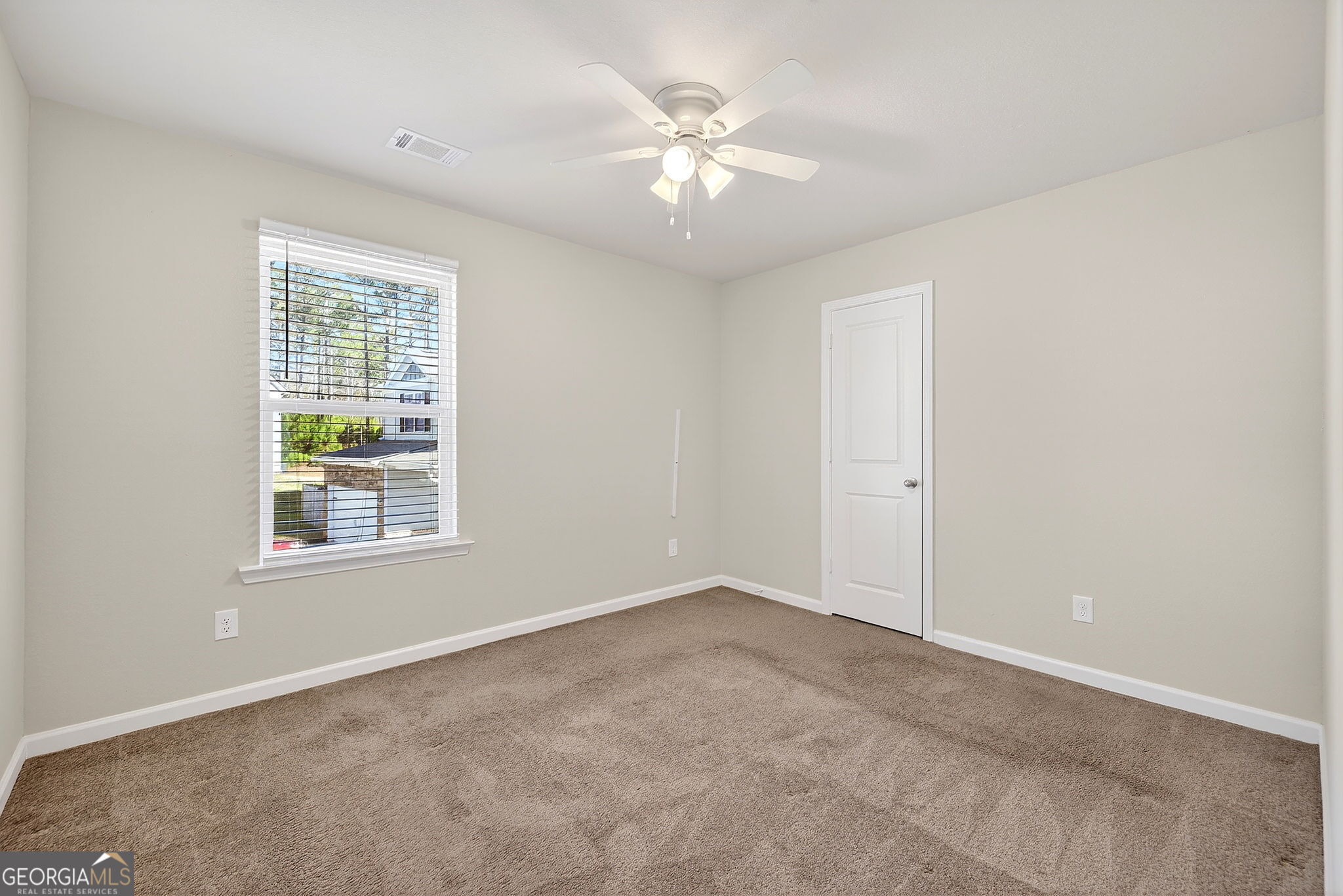 805 Golden Bell Way Villa Rica, GA 30180 - Photo 27 of 51 an empty room with windows and chandelier fan