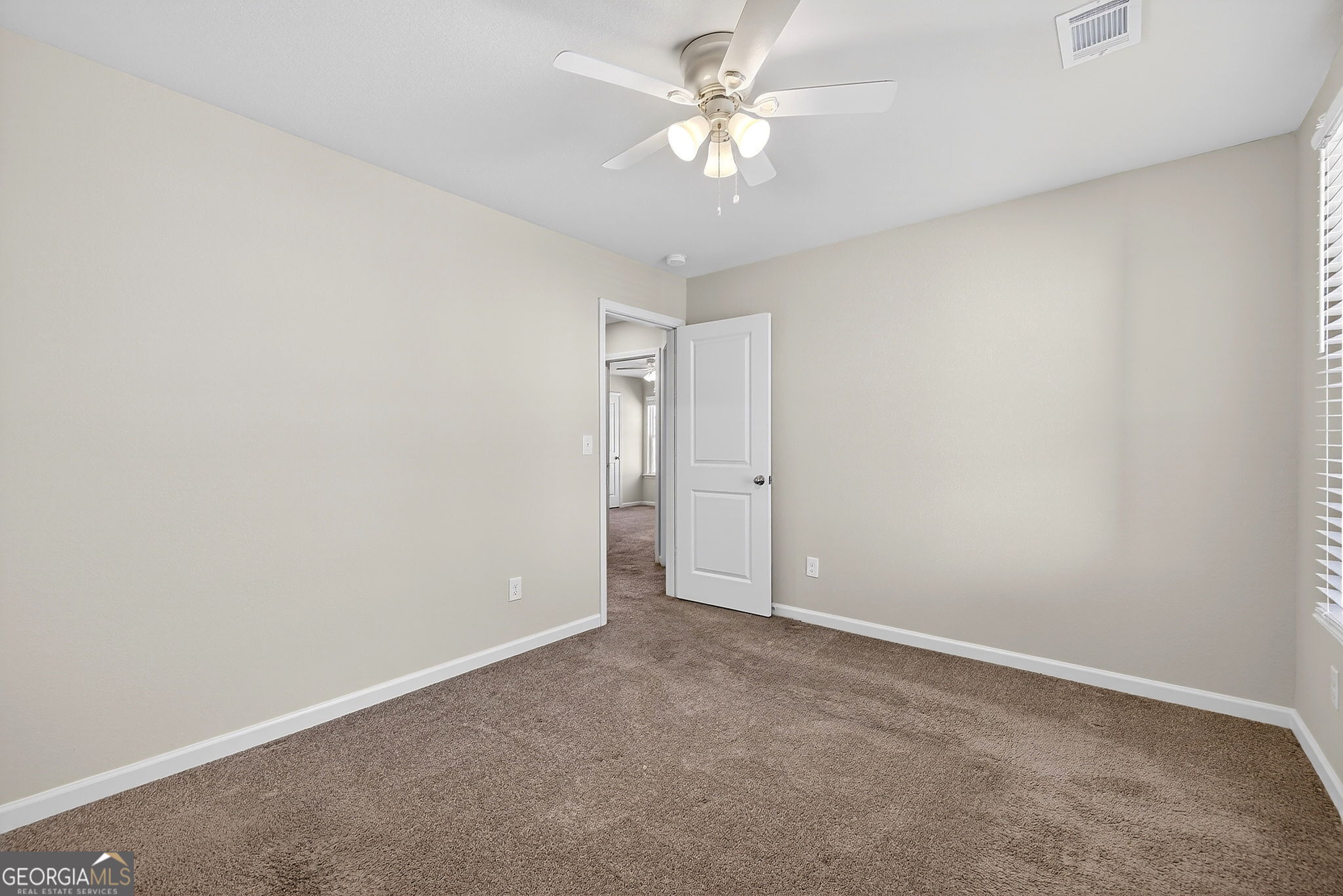 805 Golden Bell Way Villa Rica, GA 30180 - Photo 28 of 51 an empty room with a ceiling fan and a window