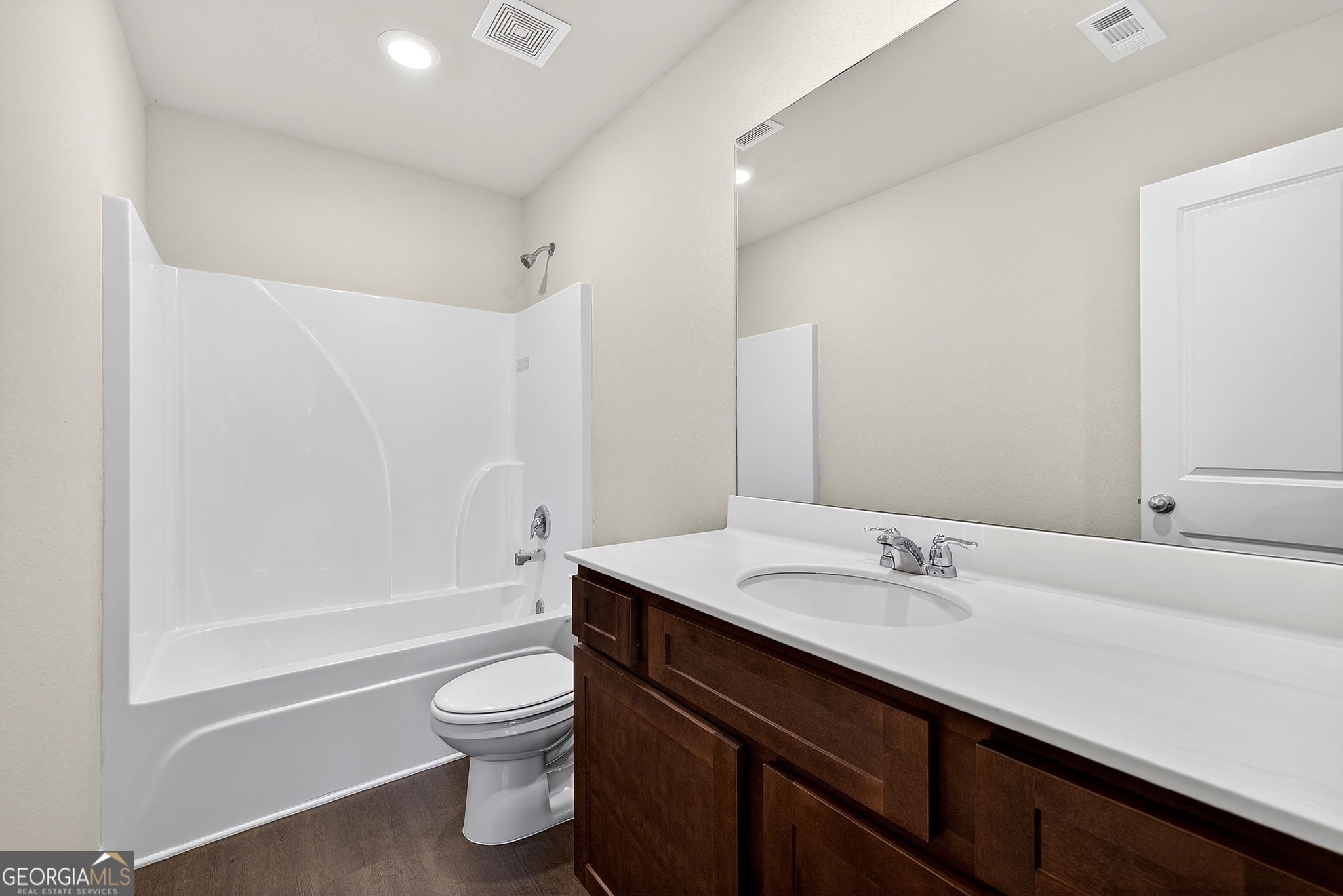805 Golden Bell Way Villa Rica, GA 30180 - Photo 29 of 51 a bathroom with a sink a toilet and a large mirror