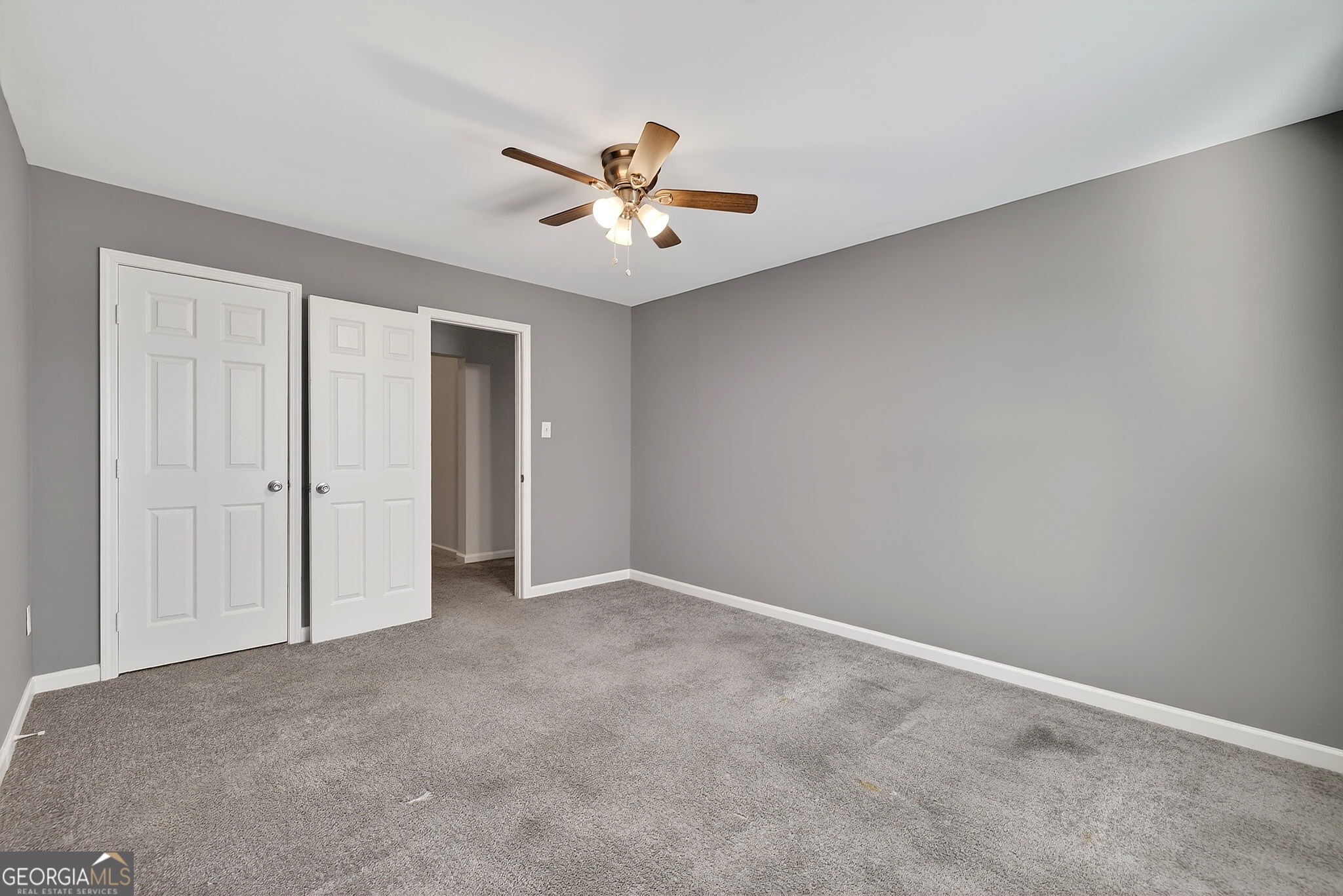 805 Golden Bell Way Villa Rica, GA 30180 - Photo 33 of 51 an empty room with closet and a ceiling fan
