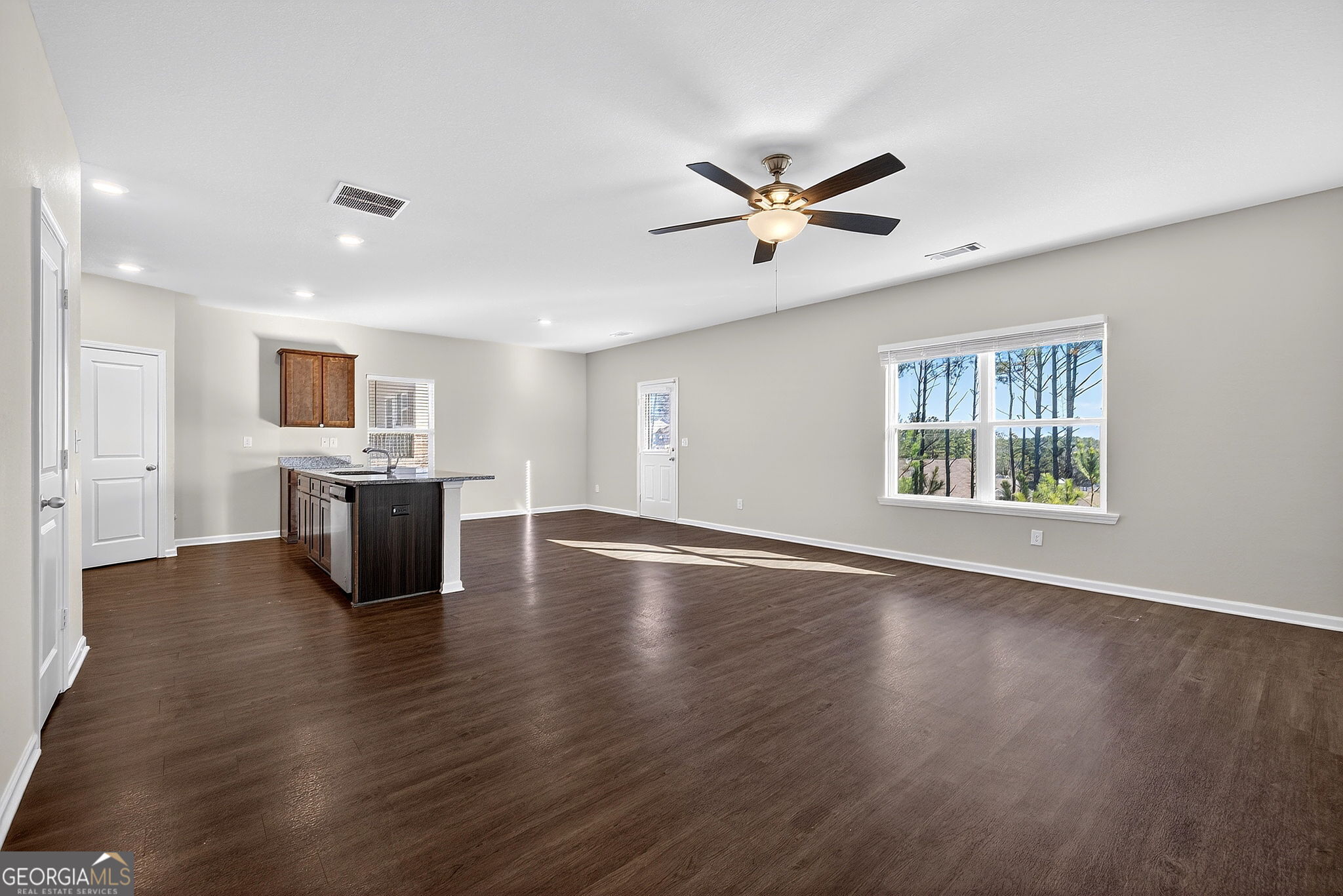 805 Golden Bell Way Villa Rica, GA 30180 - Photo 6 of 51 a view of an empty room with window and wooden floor