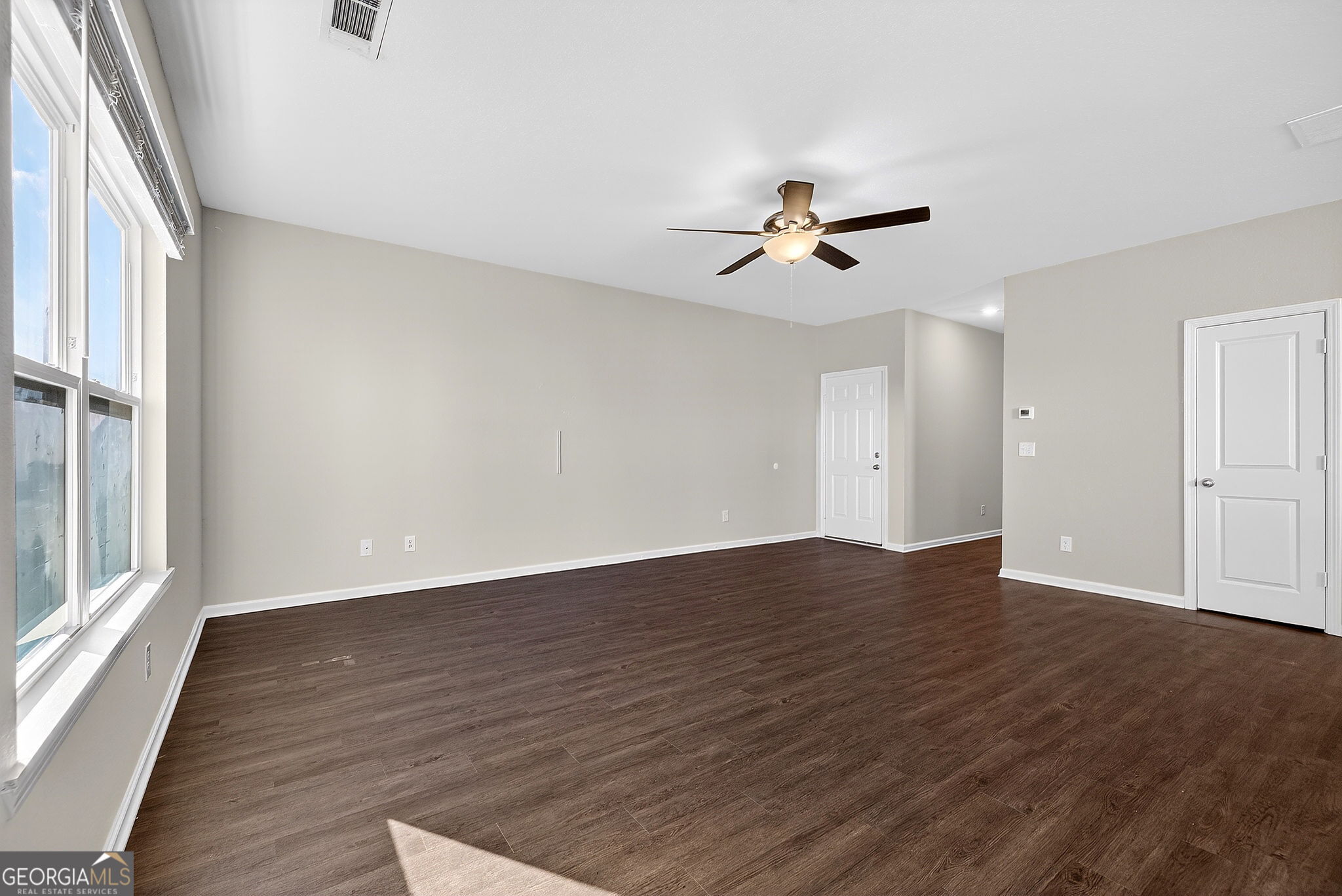 805 Golden Bell Way Villa Rica, GA 30180 - Photo 8 of 51 wooden floor in an empty room with a window