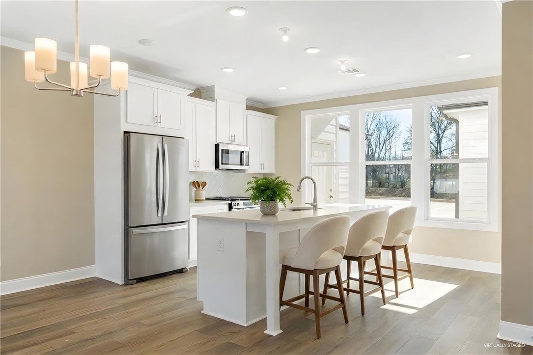 233 Black Swann Road Auburn, AL 36832 - Photo 2 of 26 This bright kitchen features sleek appliances and a spacious island, perfect for casual dining and entertaining.
