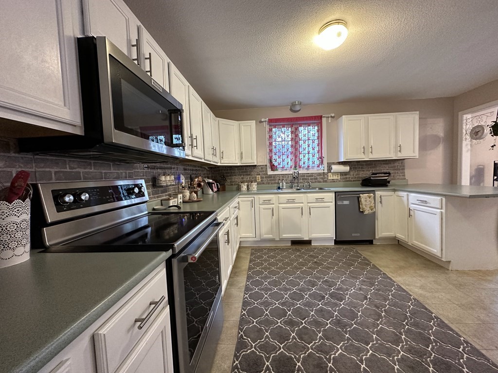 68 Lariviere Drive Chicopee, MA 01020 - Photo 15 of 42 a kitchen with a sink stove and microwave