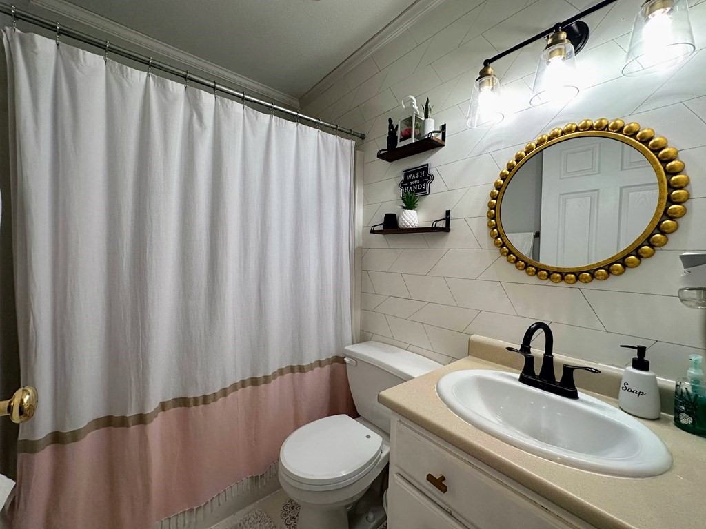 68 Lariviere Drive Chicopee, MA 01020 - Photo 19 of 42 a bathroom with a sink a toilet and a mirror