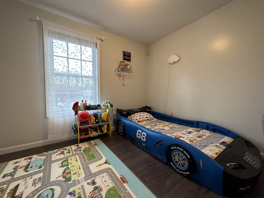 68 Lariviere Drive Chicopee, MA 01020 - Photo 21 of 42 a bed sitting in a bedroom next to a window