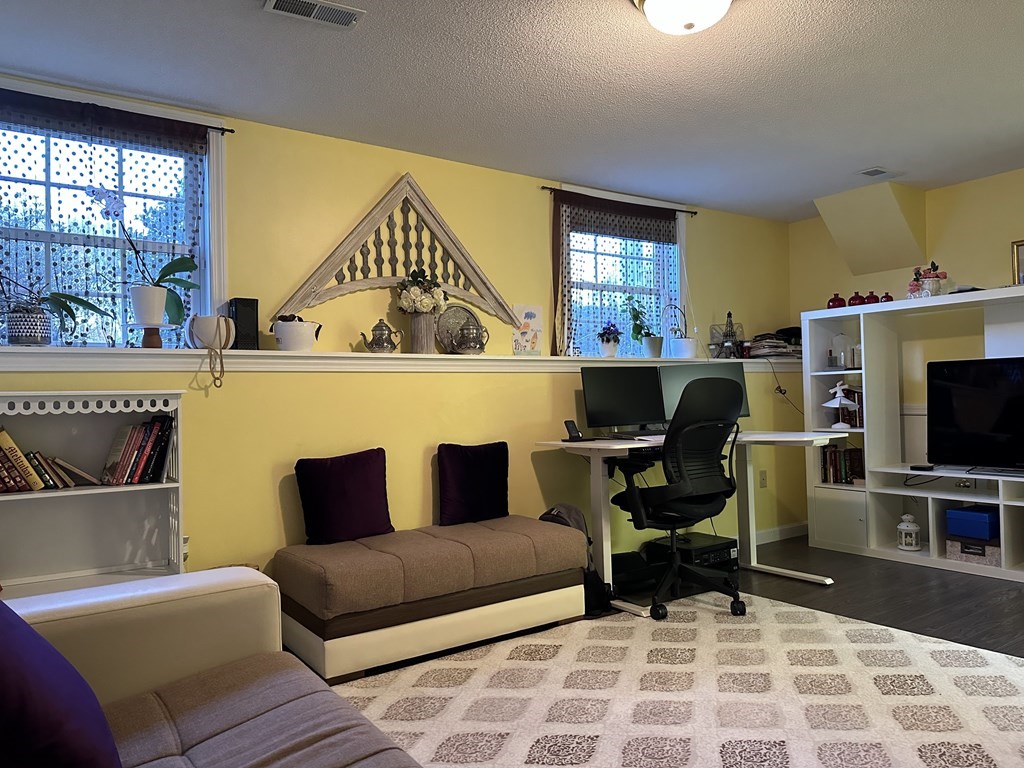 68 Lariviere Drive Chicopee, MA 01020 - Photo 32 of 42 a living room with furniture a window and a flat screen tv