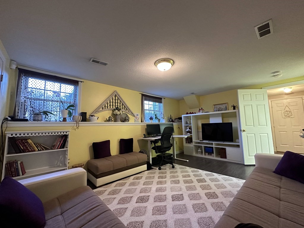 68 Lariviere Drive Chicopee, MA 01020 - Photo 33 of 42 a living room with furniture a flat screen tv and a fireplace