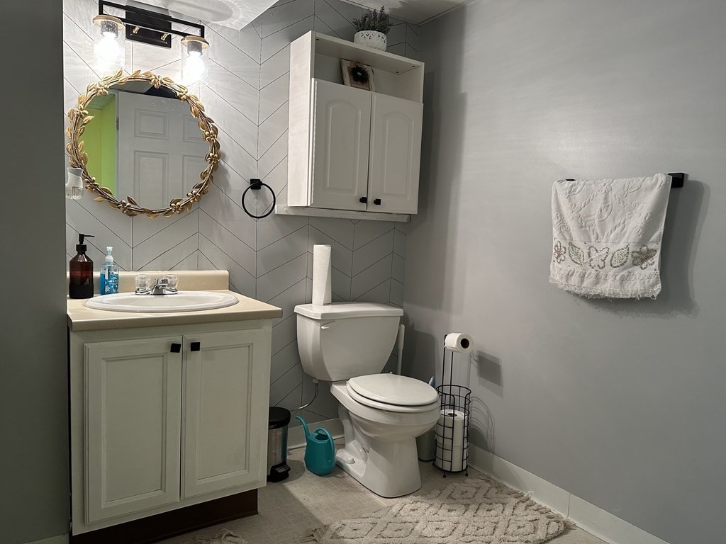 68 Lariviere Drive Chicopee, MA 01020 - Photo 35 of 42 a bathroom with a toilet a sink and mirror
