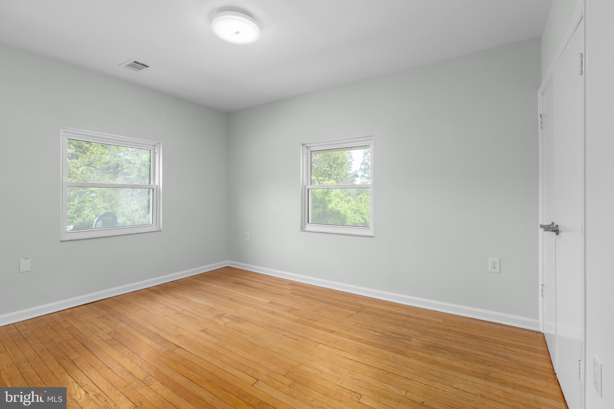 10827 Catharpin Road Spotsylvania, VA 22553 - Photo 21 of 39 an empty room with wooden floor and windows