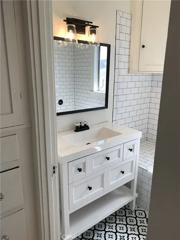 an empty room with wooden floor fireplace and windows