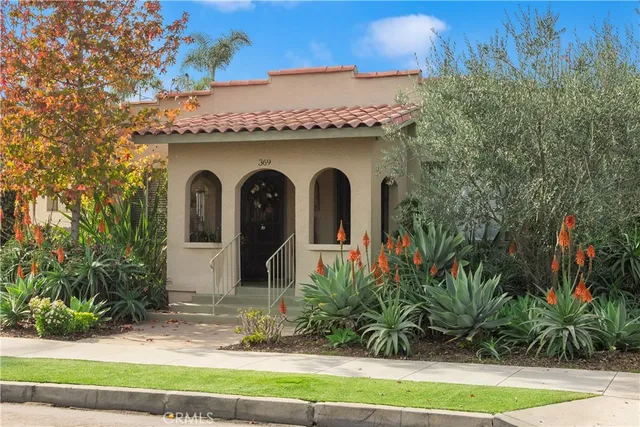 a front view of a house with garden