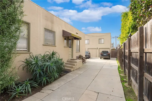 a view of a house with backyard and sitting area