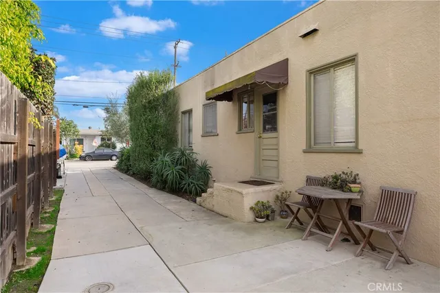 a view of a patio with a table and chairs and potted plants