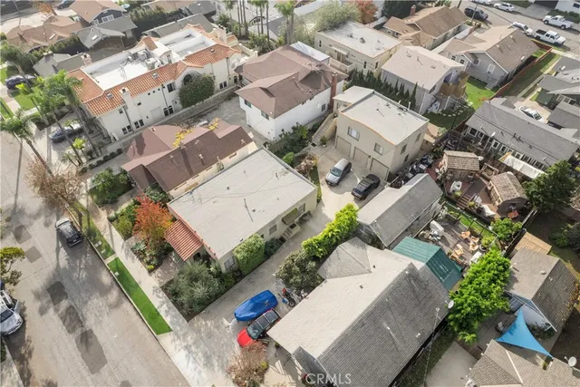 a kitchen with white cabinets and window