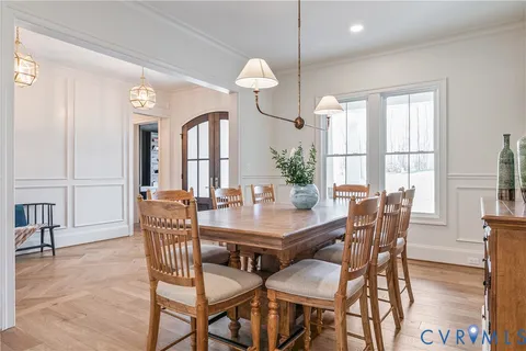 a kitchen with granite countertop a sink dining table and chairs