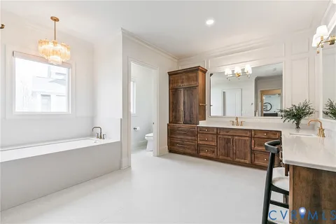 a bedroom with a bed a dresser and a window