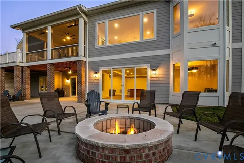 a view of a dining room with furniture a chandelier and wooden floor