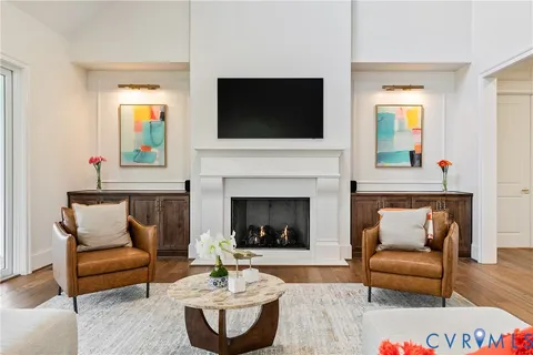 a dining room with furniture a chandelier and wooden floor
