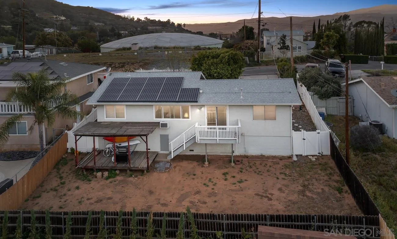 11739 Walnut Road Lakeside, CA 92040 - Photo 14 of 16 a view of a patio with table and chairs with wooden floor and fence