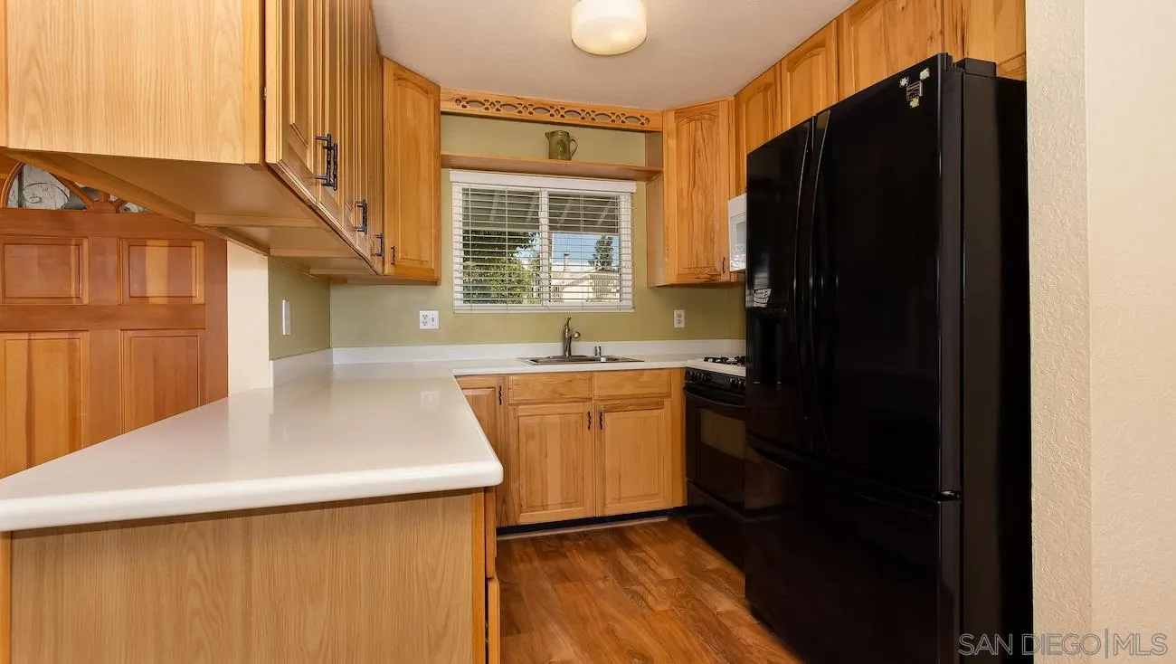 11739 Walnut Road Lakeside, CA 92040 - Photo 2 of 16 a kitchen with a refrigerator and a sink