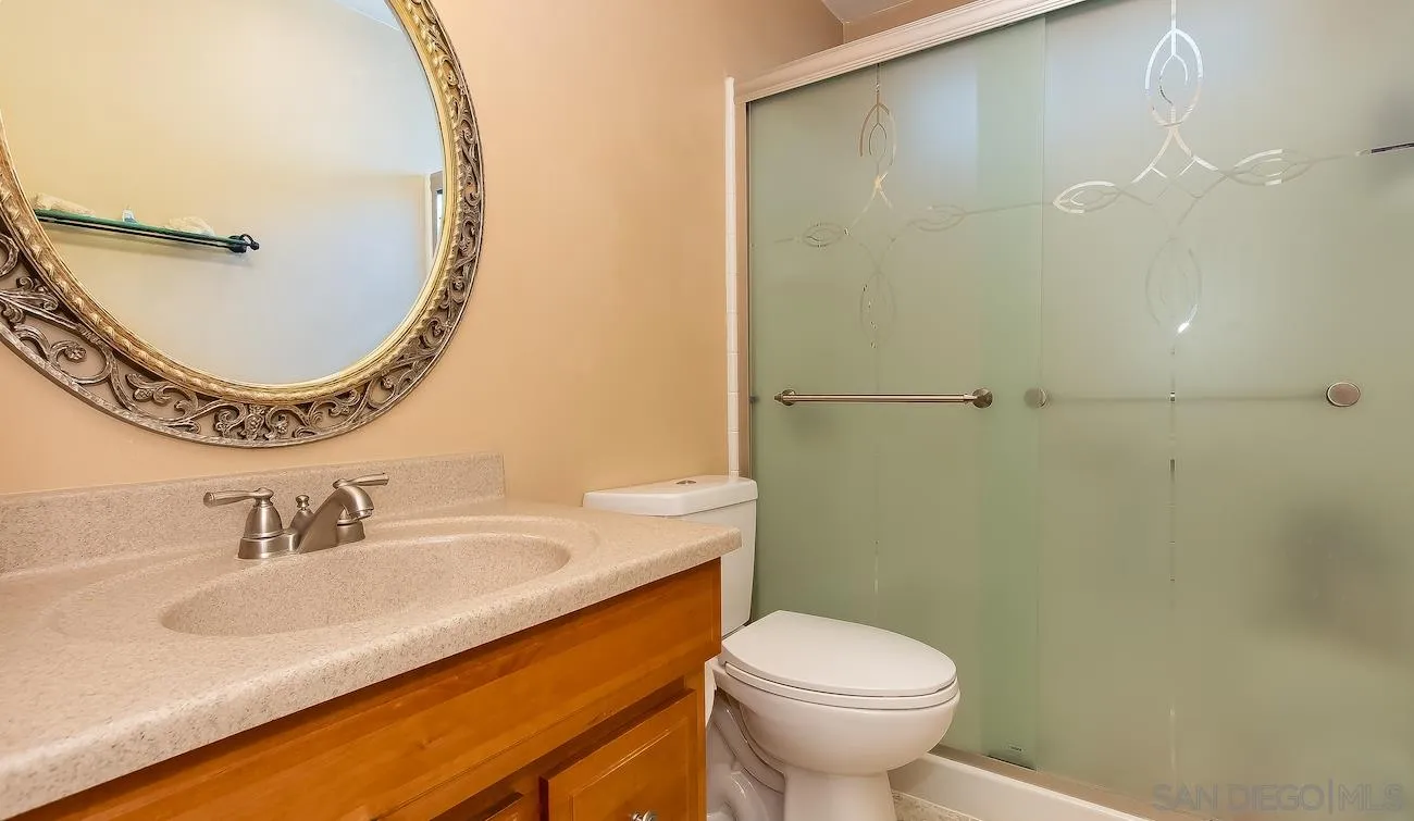 11739 Walnut Road Lakeside, CA 92040 - Photo 8 of 16 a bathroom with a sink a toilet and a mirror