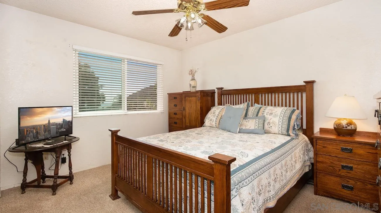 11739 Walnut Road Lakeside, CA 92040 - Photo 9 of 16 a bed room with a bed and a television