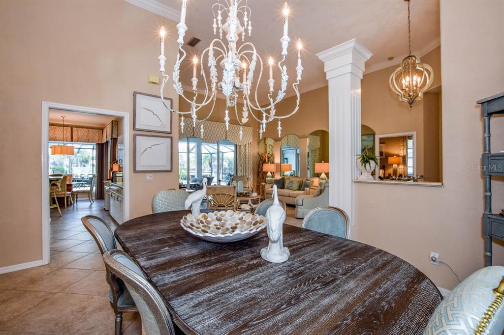 429 Tremingham Way Venice, FL 34293 - Photo 11 of 73 a view of a dining room with furniture and chandelier