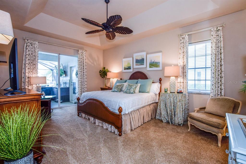 429 Tremingham Way Venice, FL 34293 - Photo 20 of 73 a bedroom with a bed couch chandelier and a window