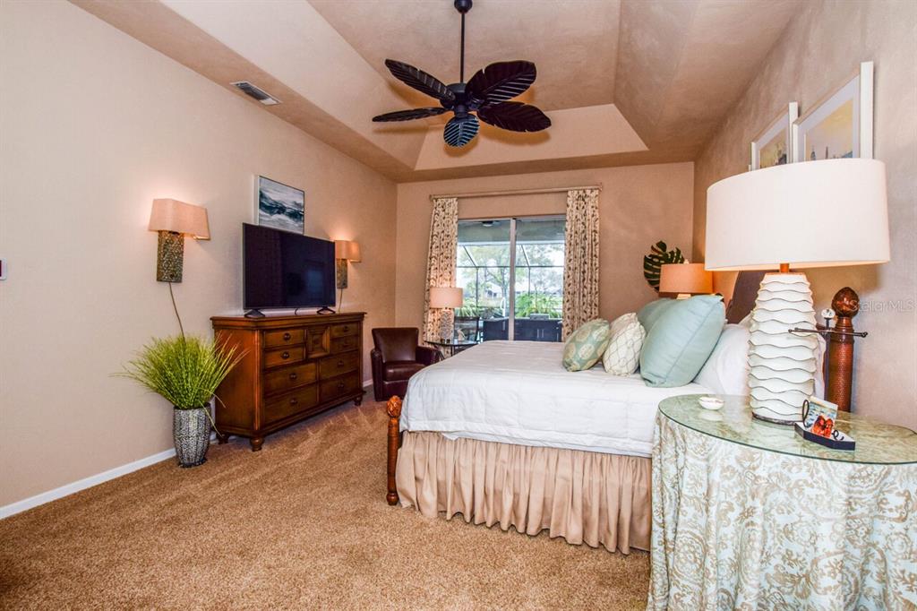 429 Tremingham Way Venice, FL 34293 - Photo 22 of 73 a bed room with a bed window and a flat screen tv