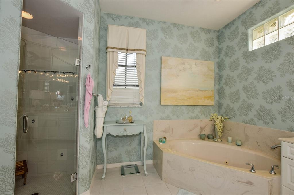 429 Tremingham Way Venice, FL 34293 - Photo 25 of 73 a bathroom with a bathtub a shower a sink and a window