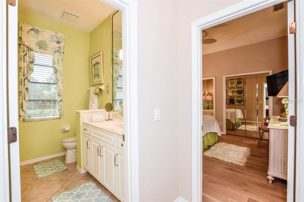 429 Tremingham Way Venice, FL 34293 - Photo 26 of 73 a bathroom with a granite countertop sink mirror vanity and toilet