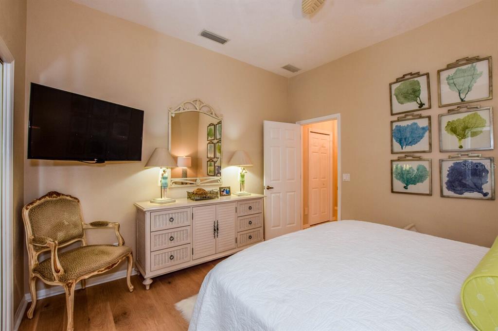 429 Tremingham Way Venice, FL 34293 - Photo 28 of 73 a bedroom with a bed and a flat screen tv