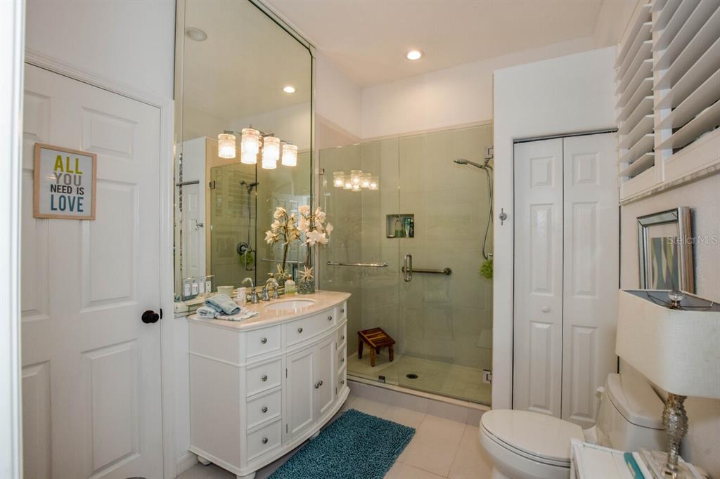 429 Tremingham Way Venice, FL 34293 - Photo 30 of 73 a bathroom with a sink a toilet a mirror and shower