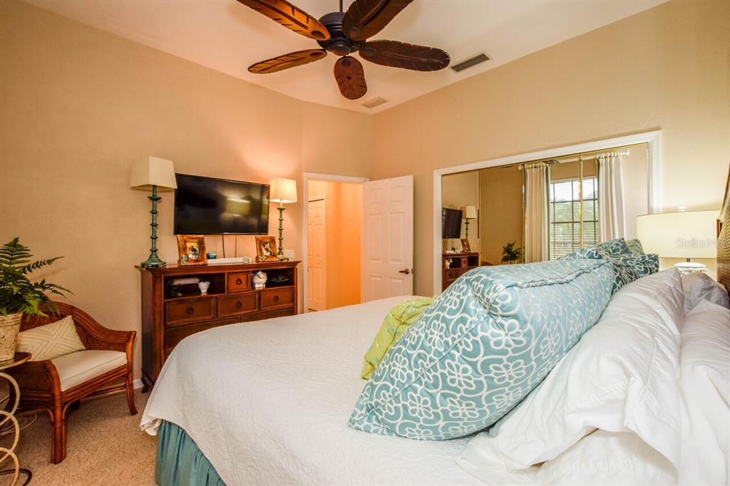 429 Tremingham Way Venice, FL 34293 - Photo 31 of 73 a bedroom with a bed and a flat screen tv