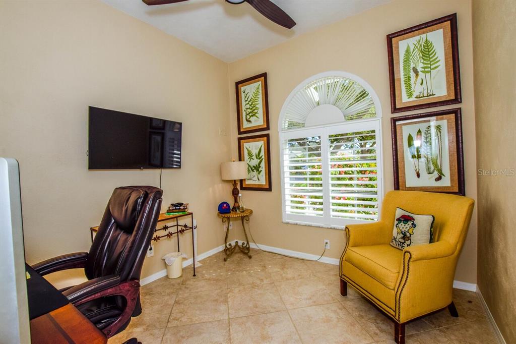 429 Tremingham Way Venice, FL 34293 - Photo 32 of 73 a living room with furniture a flat screen tv and a window