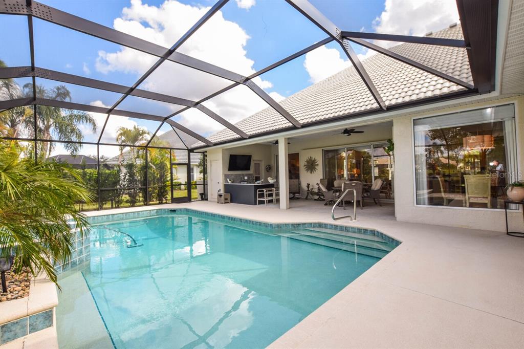 429 Tremingham Way Venice, FL 34293 - Photo 40 of 73 a view of a swimming pool with outdoor seating