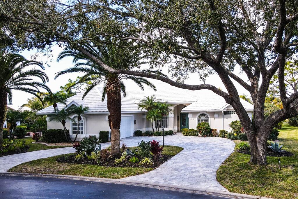 429 Tremingham Way Venice, FL 34293 - Photo 48 of 73 a front view of a house with garden and trees