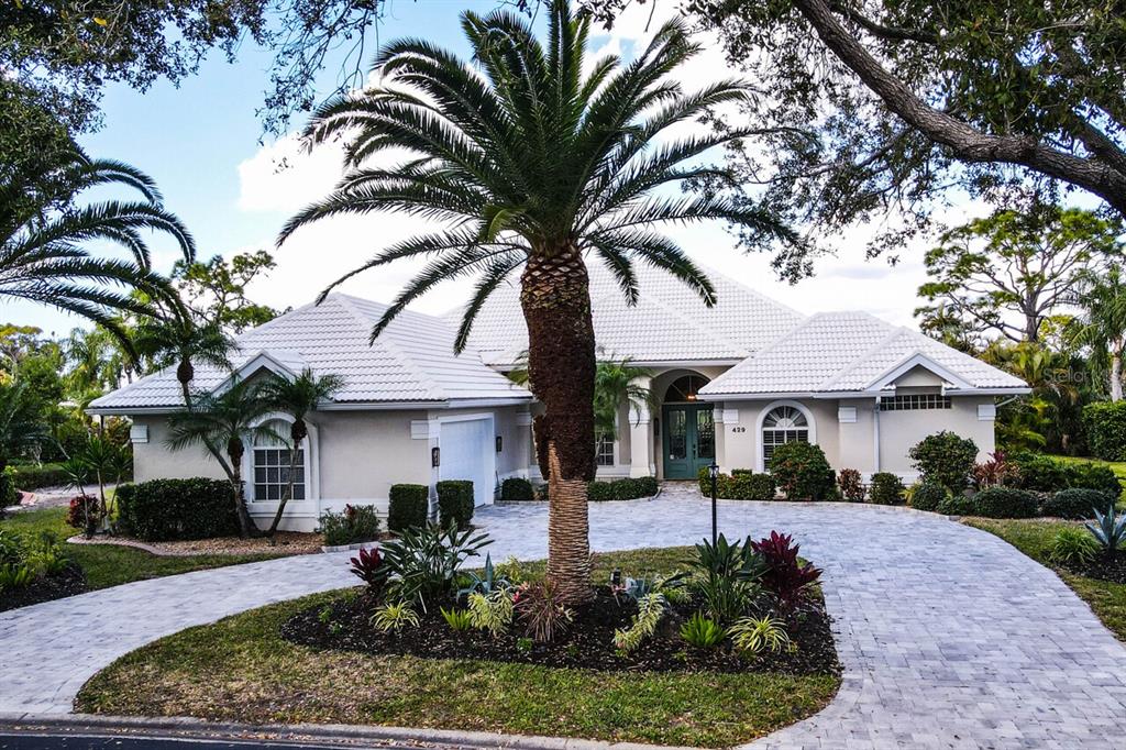 429 Tremingham Way Venice, FL 34293 - Photo 49 of 73 a front view of a house with garden and tree